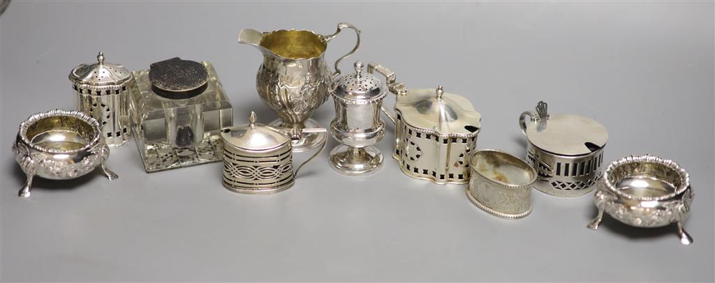 A collection of small silver items, comprising a George III helmet-shaped embossed cream jug,